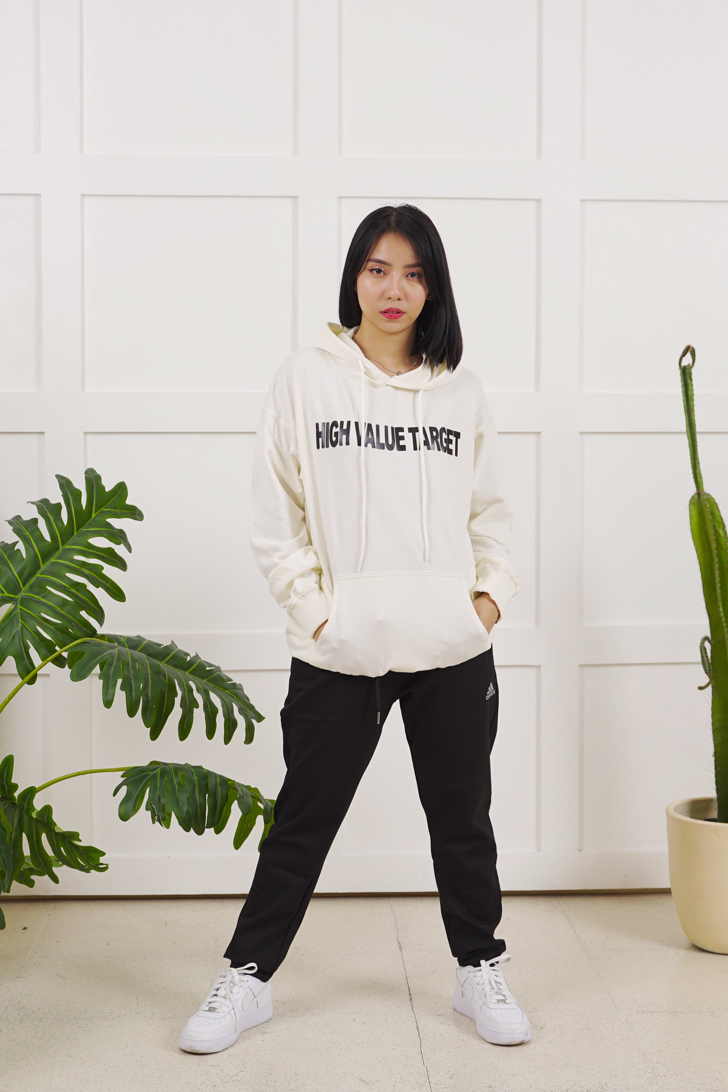 Cream streetwear hoodie with HVT lettering on front, clean high value target logo design in modern urban style