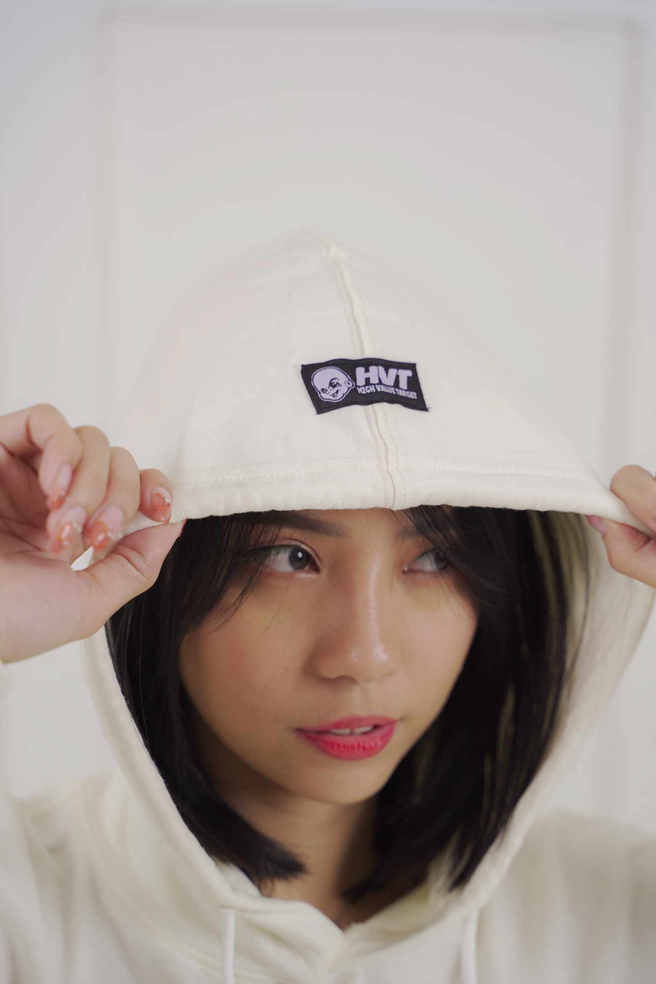 Minimalist pullover hoodie in cream color with small chest design, perfect for clean streetwear aesthetic outfit