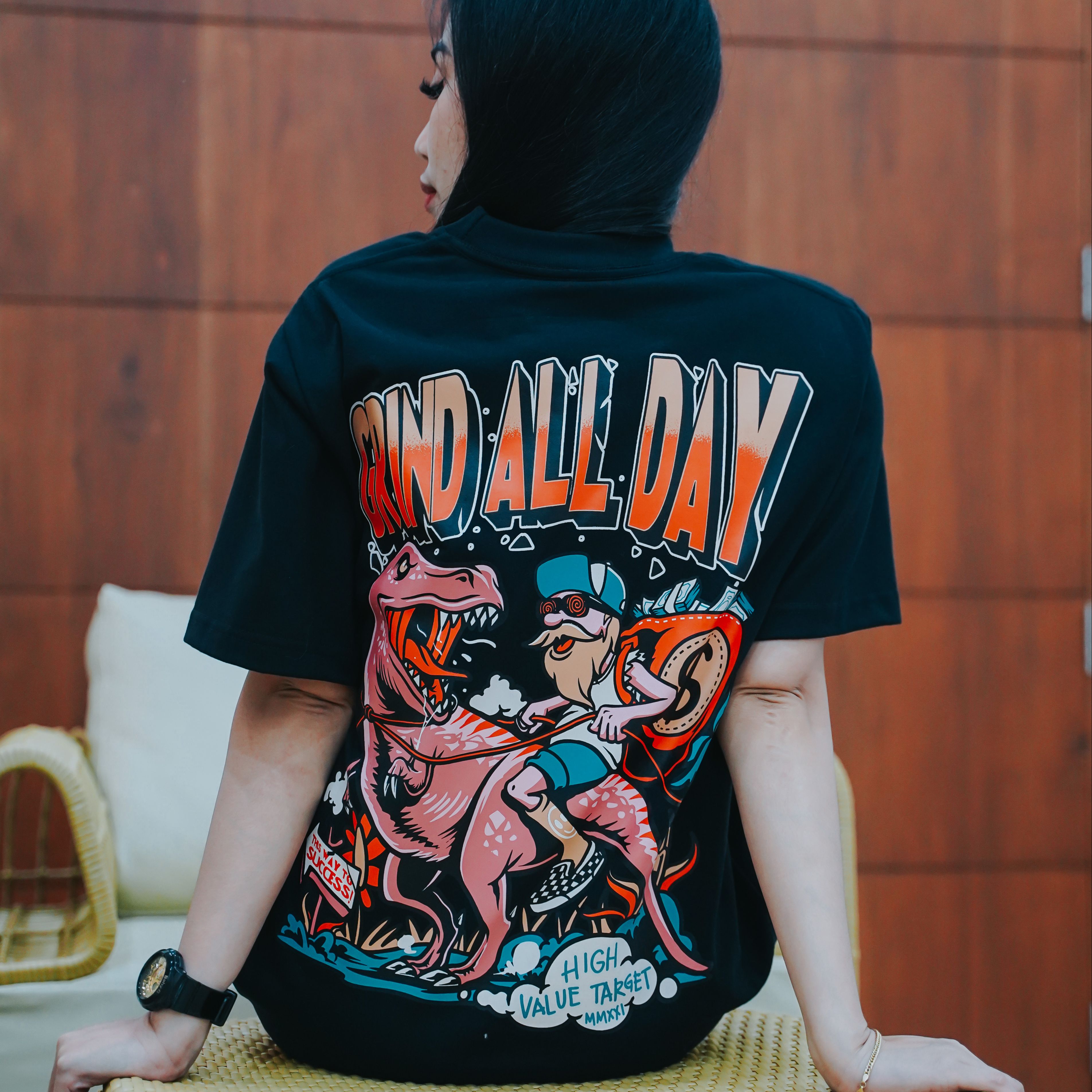 Grind All Day graphic T shirt with illustrated character riding creature and money theme