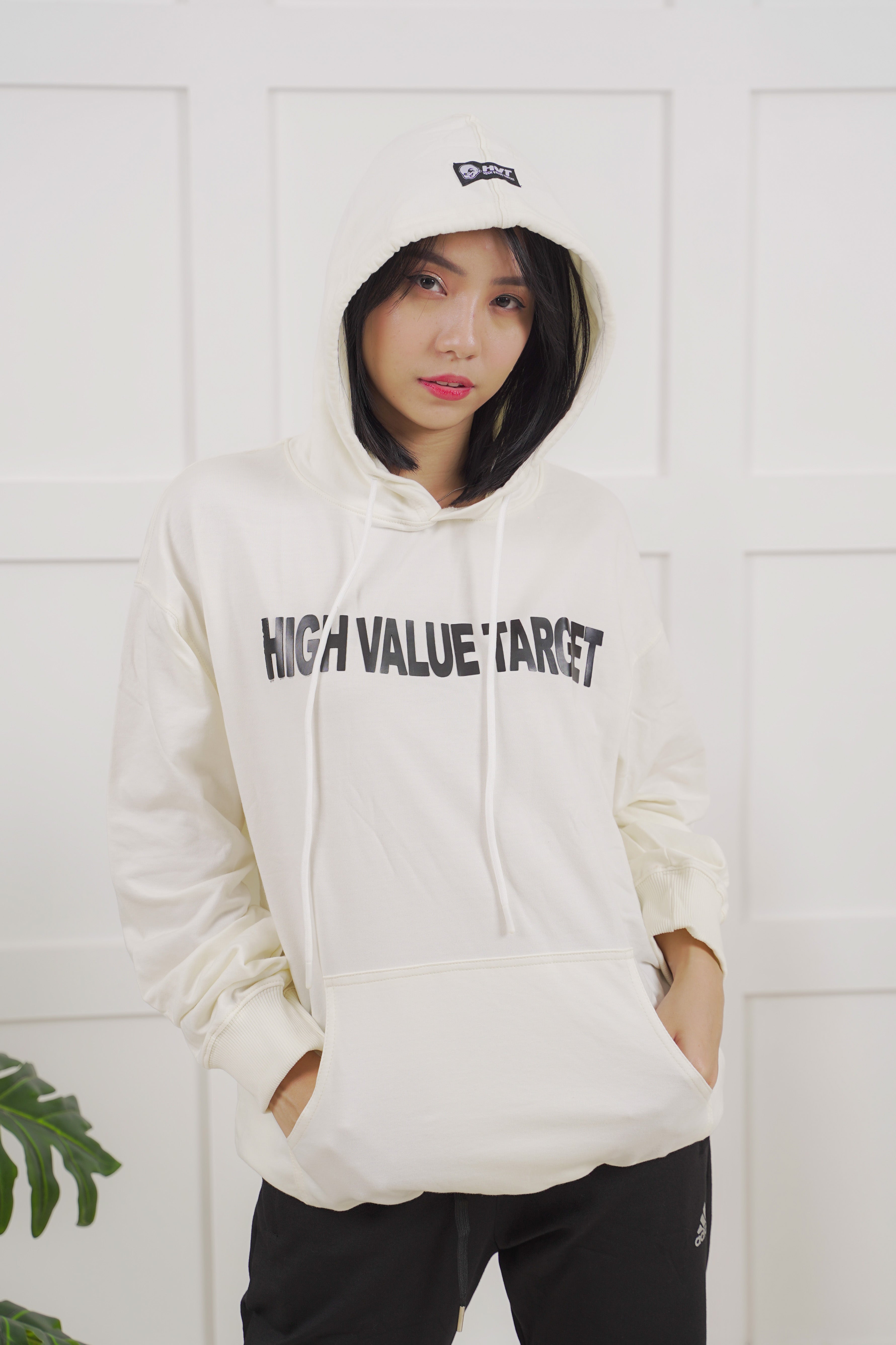 Cream hoodie featuring HVT logo on chest, clean minimal streetwear design with bold lettering front print