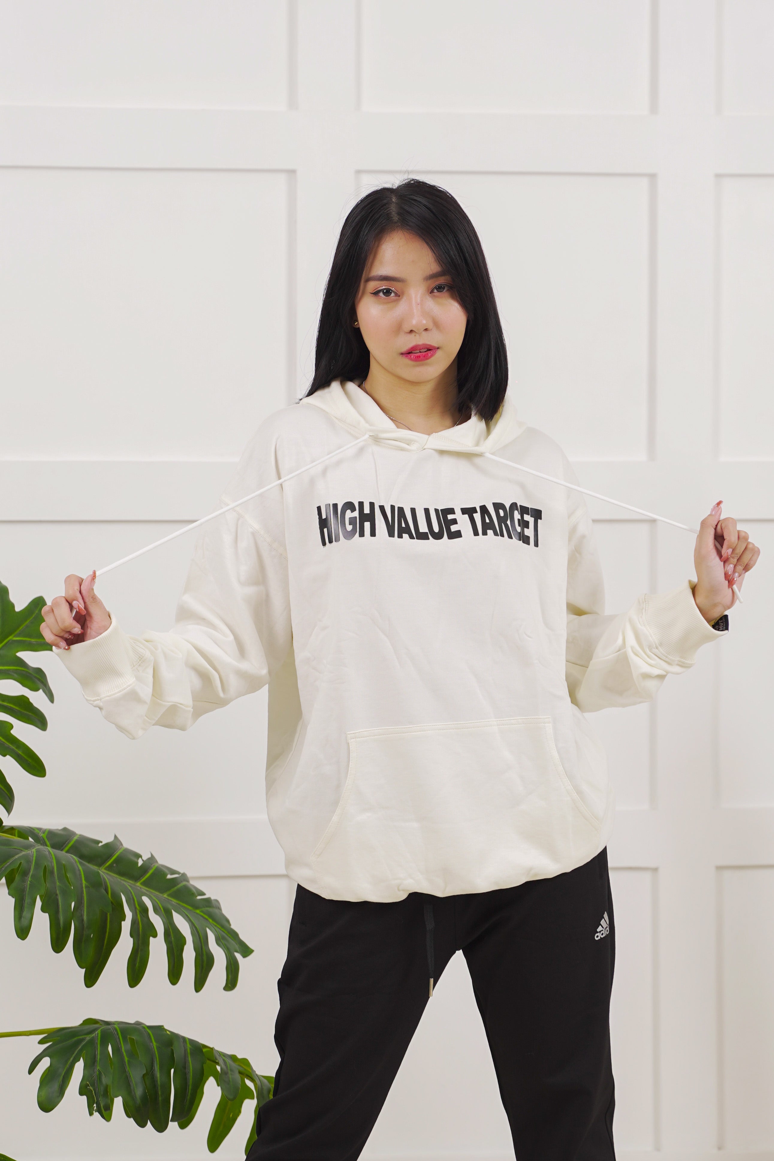 Neutral tone pullover hoodie featuring simple front chest graphic, minimal aesthetic for everyday streetwear style