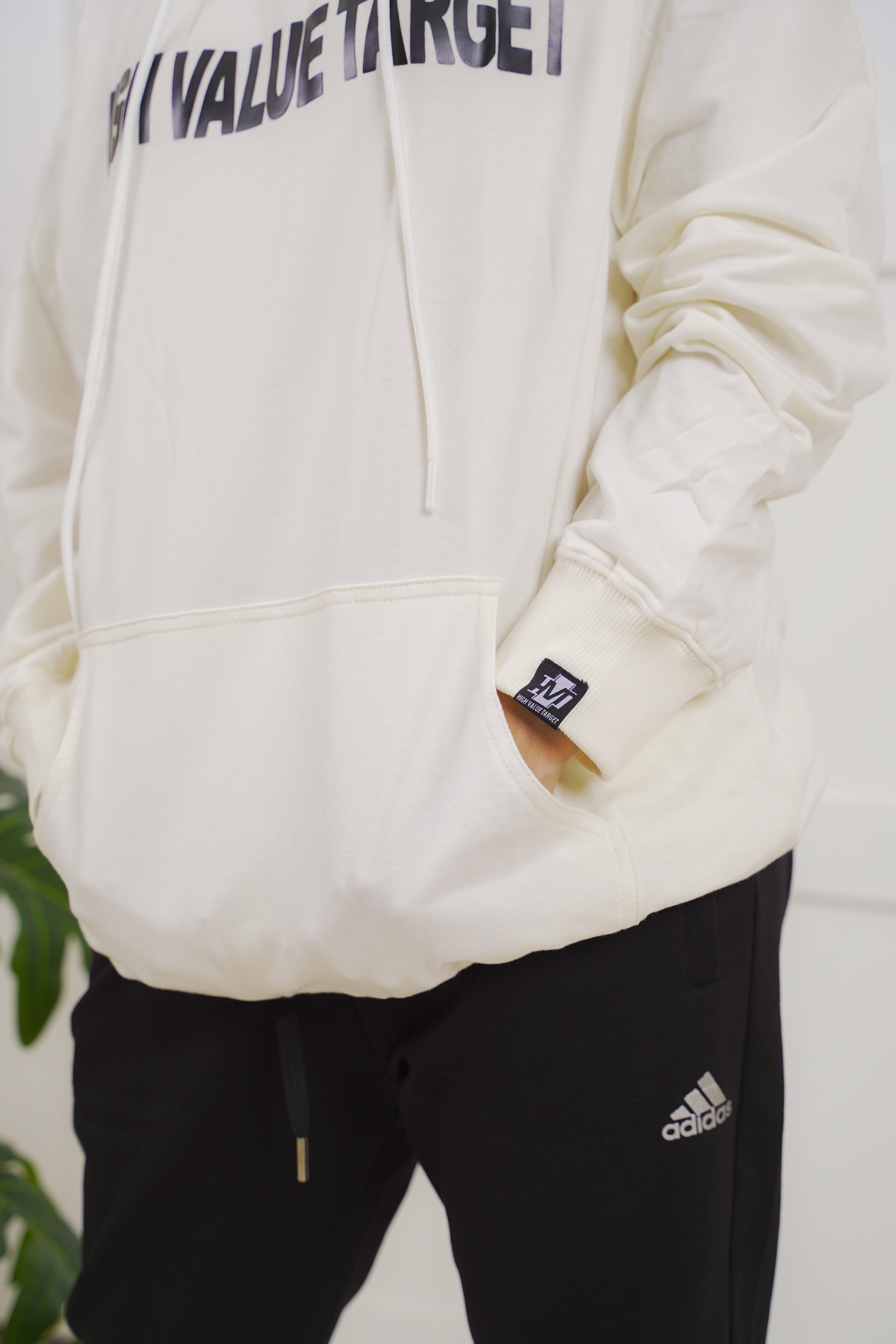 Light beige hoodie with subtle chest print, sleek minimal look designed for casual urban fashion wear