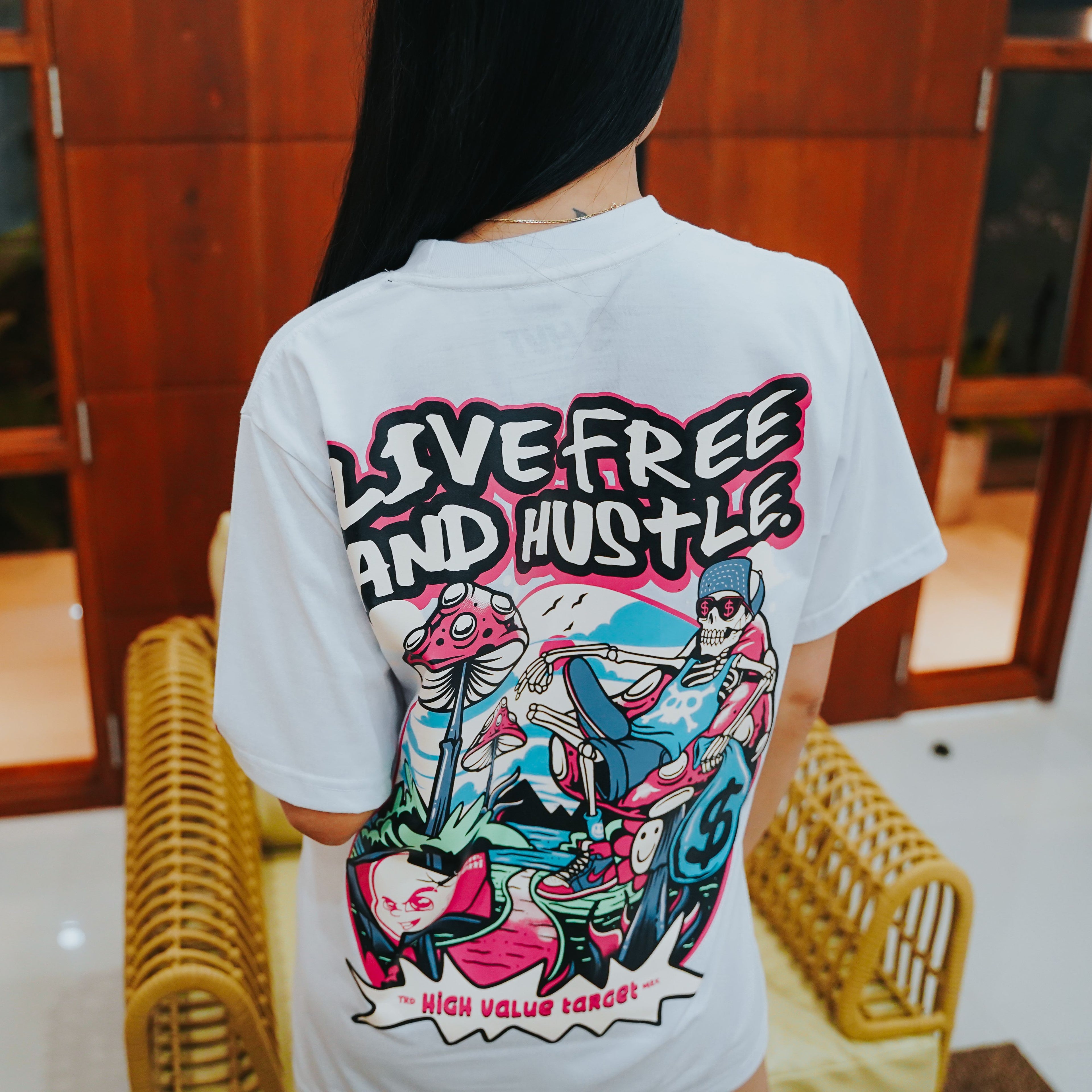 Urban fashion t-shirt with skeleton relaxing holding money, mushrooms detail and Live Free and Hustle text design