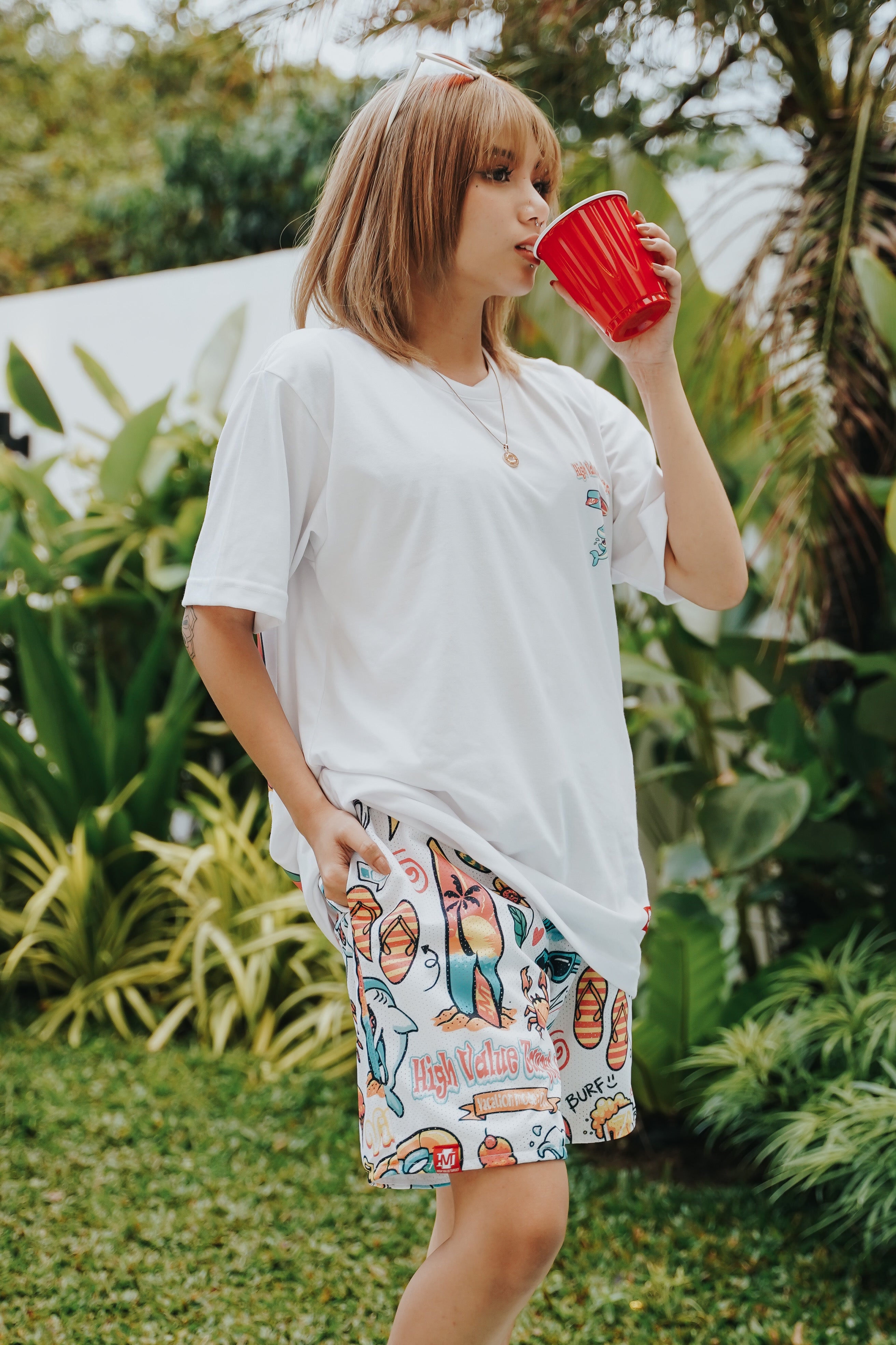 Vacation themed mesh shorts with all over icon print, breathable fabric and relaxed fit for summer streetwear style