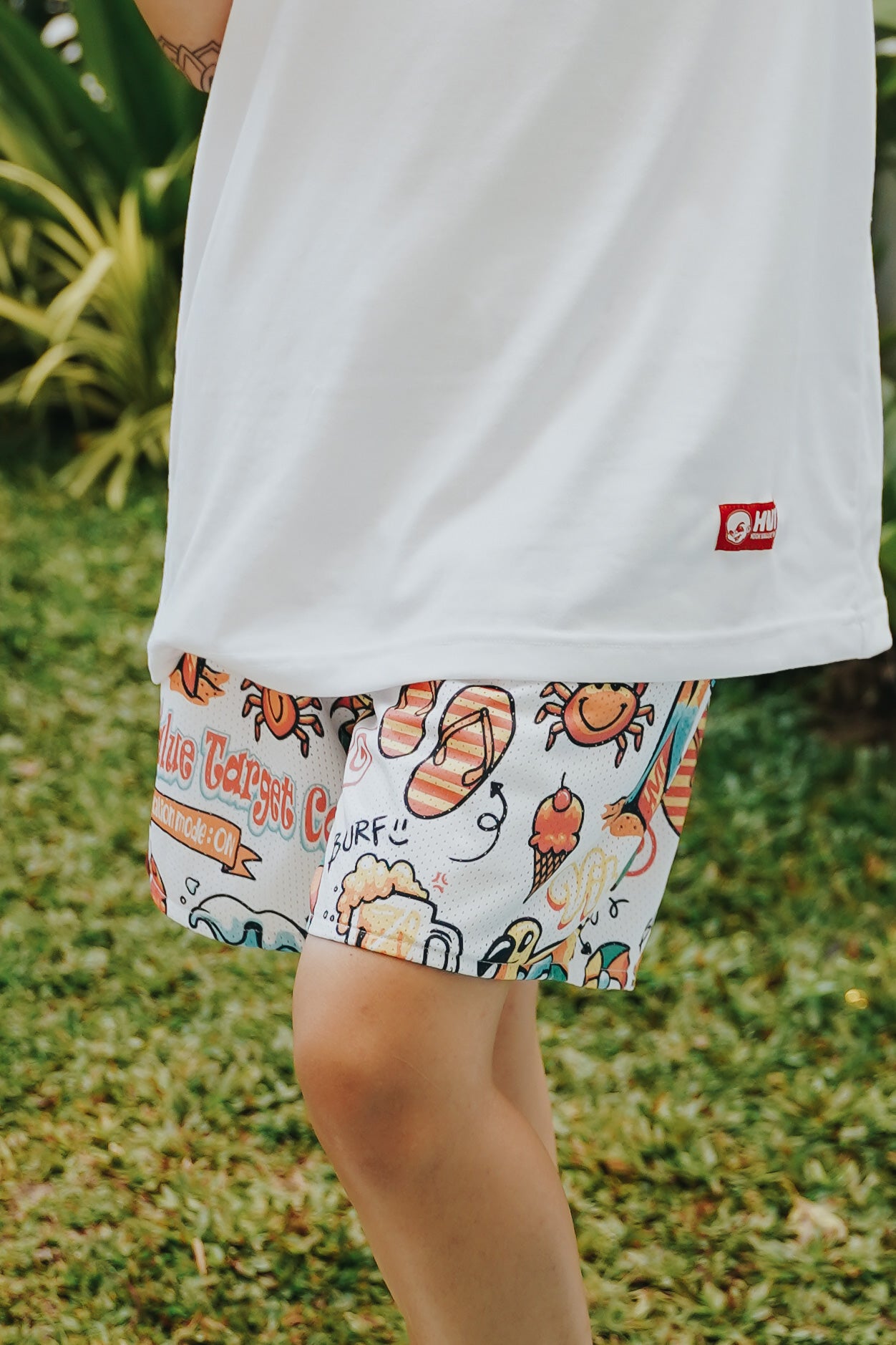 Graphic mesh shorts with Vacation Mode On text and mixed holiday icons, comfortable design for warm weather outfits